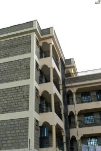 a building with balconies on the side of it at Saas Homestay in Eldoret