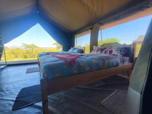 a bed in a room with a tent at KANUNKA HOUSE in Sekenani