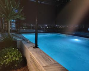 a large swimming pool at night with a city skyline at RUBY HOTEL Vĩnh Long in Vĩnh Long