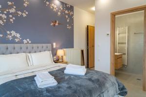 a bedroom with a large bed with towels on it at Kostis Orange Resort in Volos