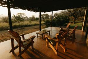 a group of chairs and a table on a porch at Sensiri in Mkuze