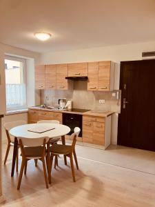 a kitchen with a table and some chairs and a table and a table at Apartament na Rynku in Wągrowiec