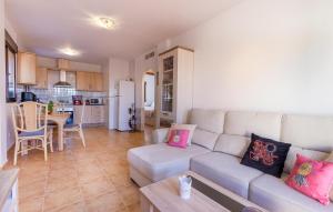 a living room with a couch and a kitchen at Gorgeous Home In Cartagena With Wifi in Cartagena