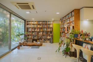 a library with bookshelves filled with books at Motif No.1 Guest House in Paju