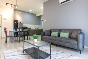 a living room with a couch and a table at Atlantis Residence - Modern Luxury in Melaka