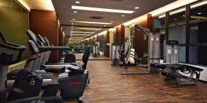 a gym with rows of treadmills and machines at Atlantis Residence - Modern Luxury in Melaka