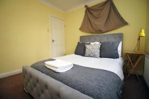 a bedroom with a bed with two pillows on it at Chartwell Grove (Spacious 7 BR with FREE parking) in Nottingham