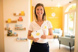 a woman holding a piece of paper in a room at Les Maisons de Port Bourgenay - maeva Home - Maison 3 pièces 6 personnes - Sélection MAE-6402 in Talmont +19 photos