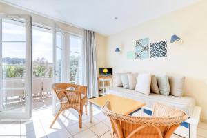 a living room with a couch and a table and chairs at Les Maisons de Port Bourgenay - maeva Home - Maison 3 pièces 6 personnes - Sélection MAE-6402 in Talmont