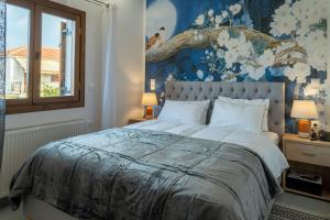 a bedroom with a large bed with a floral wallpaper at Kostis Orange Resort in Volos