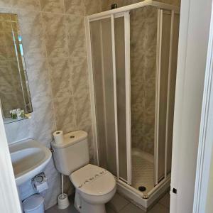 a bathroom with a shower and a toilet and a sink at Marazul By Fitzgeralds in Nerja +21 photos