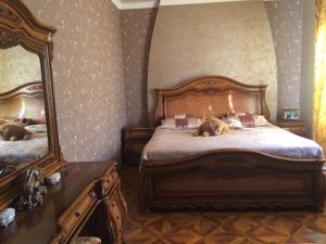 a dog laying on a bed in a bedroom at Sargsyan’s House in Gyumri