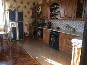 a kitchen with a refrigerator and a washer and dryer at Sargsyan’s House in Gyumri