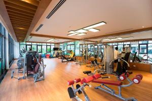 a gym with a bunch of cardio equipment in it at Blue Rose - Sea View, High Floor, 70m2 apartment, 2 Bedrooms, 2 WC, in Ha Long