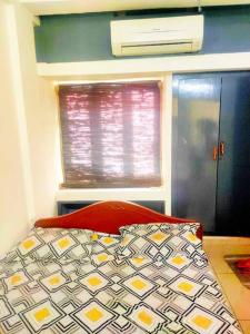a bed in a room with a window and a bed sidx sidx sidx at Good stay service apartments cenotaph road in Chennai