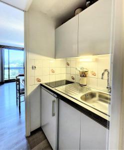 a kitchen with a sink and a counter top at Résidence Phenix - RESIDENCE PHENIX STUDIO POUR 4 PERSONNES MAE-9884 in Le Corbier