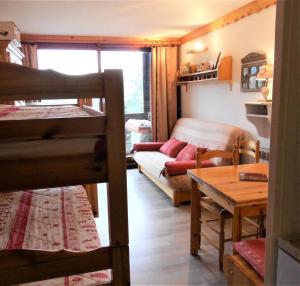 a living room with a bunk bed and a couch at Résidence Phenix - RESIDENCE PHENIX STUDIO POUR 4 PERSONNES MAE-9884 in Le Corbier