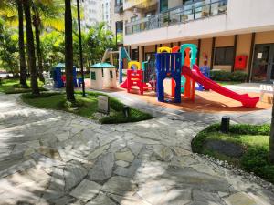 a playground in front of a building at Apartamento Barra Olímpica - Condomínio Fontano in Rio de Janeiro