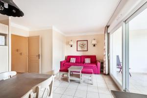 a living room with a red couch and a table at Les Coteaux de Pont Royal en Provence - maeva Home - Appartement 2 Pièces 6 Personnes - Sélection MAE-8180 in Mallemort