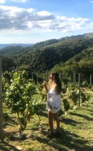 a woman standing in a vineyard looking up at the sky at Establecimiento La Soleada suites de campo in La Cumbre