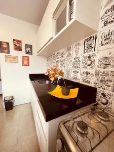 a kitchen with a counter with a yellow bowl on it at Loft encantador A - 8 km de Floripa in São José