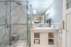 a bathroom with a sink and a glass shower at Rare Luxury Gem in the Most Elite Area near Syntagma Square in Athens
