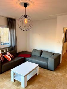 a living room with a couch and a table at Alex in Pfaffenhausen