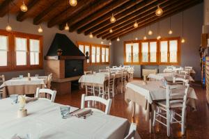 a dining room with white tables and chairs at Agriturismo Da Celestina in Arzignano