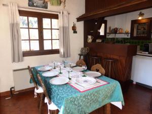 a table in a kitchen with a blue table cloth at Chalet Santa Claus - Chalets pour 8 Personnes 284 in Les Contamines-Montjoie