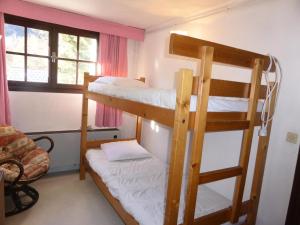 a room with two bunk beds and a couch at Chalet Santa Claus - Chalets pour 8 Personnes 284 in Les Contamines-Montjoie