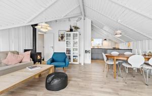 a living room with a couch and a table at Cozy Home In Ebeltoft With Wi-Fi in Ebeltoft