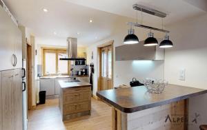 a kitchen with a large island in the middle at Chalet De Manou - Pièces 694 in Saint-Martin-de-Belleville