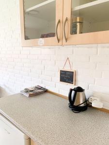 a kitchen counter with a tea kettle on a counter top at 5 minute walk to LEGO HOUSE - Best location-Garden on site-n3 in Billund