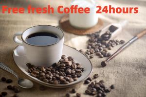 a cup of coffee and a plate of coffee beans at Wenjun Courtyard Hotel ---5 mins walk from Tonghuimen metro station, near Tianfu square, close by culture park and Sichuan opera house, English speaking service, local tours in Chengdu