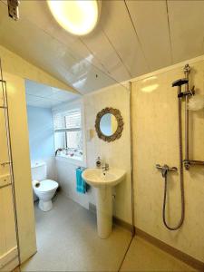 a bathroom with a sink and a toilet at Ameliafield Cottage, Prestwick in Prestwick