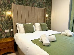 a bedroom with two beds with towels on them at Gwydyr Hotel in Betws-y-coed