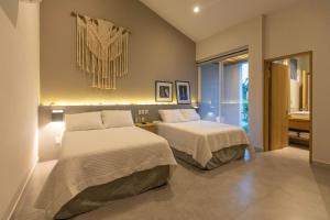 Ένα ή περισσότερα κρεβάτια σε δωμάτιο στο Casa Yoo tu oasis de lujo en Huatulco +11 φωτογραφίες