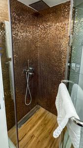 a bathroom with a shower with a glass door at Silver 39 Corner Hotel in Tbilisi City