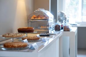 a bakery with cakes and pastries on a counter at Airone City Hotel in Catania
