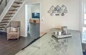 Sala de estar con silla, mesa y TV en Beautiful Home In Rysstad With Kitchen, en Rysstad