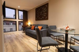 a living room with a couch and a table at CONDE13 Lisboa - Superior Charm Apartments in Lisbon