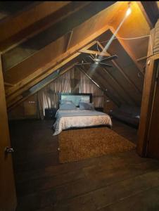 a bedroom with a bed in a attic at Cabaña sierra de lobos in Las Palomas