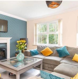 a living room with a couch and a table at Beautiful Large Property, Sleeps 9 Walking Distance to the Sea , Beaches and Restaurants Fantastic Interior in Lyme Regis