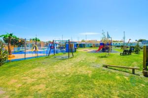 an empty park with a playground with at SP150 - Camber Sands Holiday Park - Sleeps 8 - 3 Bedrooms - En-suite - Decking - Private Parking in Camber