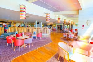 a restaurant with tables and chairs in a mall at SP158 - Camber Sands Holiday Park - 3 Bedrooms - Second Toilet - Decking - Private Parking in Camber