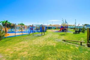 an empty park with a playground with at SP158 - Camber Sands Holiday Park - 3 Bedrooms - Second Toilet - Decking - Private Parking in Camber