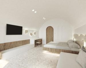 um quarto com uma cama e uma televisão na parede em Sun Aeriko em Tinos Town