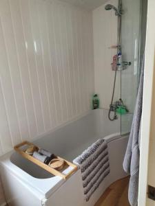 a white bathroom with a tub and a shower at MP709 - Parkdean Resorts, Camber Sands in Camber +4 photos