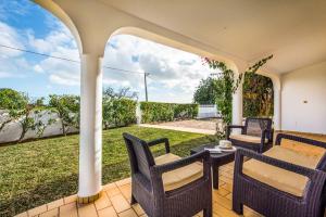 an outdoor patio with chairs and a table at Villa Barrancos in Guia