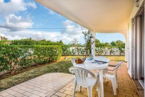 a white table and chairs on a patio with a view at Villa Barrancos in Guia